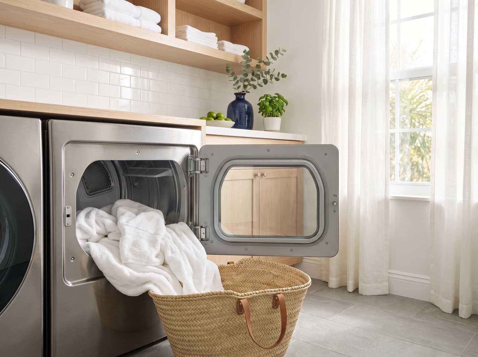 Dryer door open with dry white towels